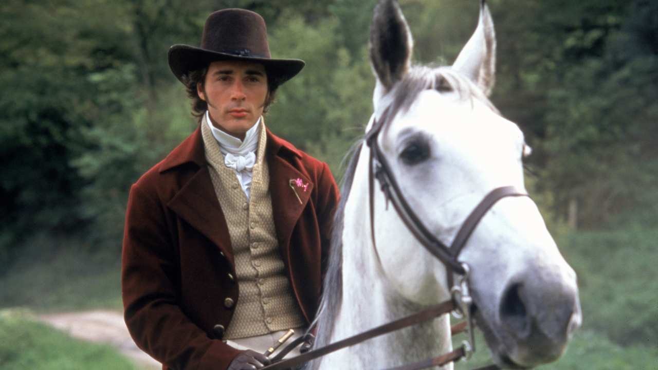 a man with a hat on a white horse