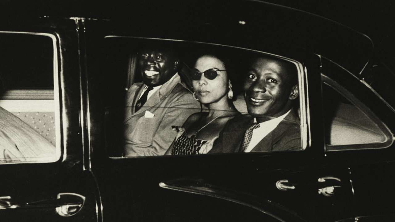 a woman with sunglasses and two men in a car