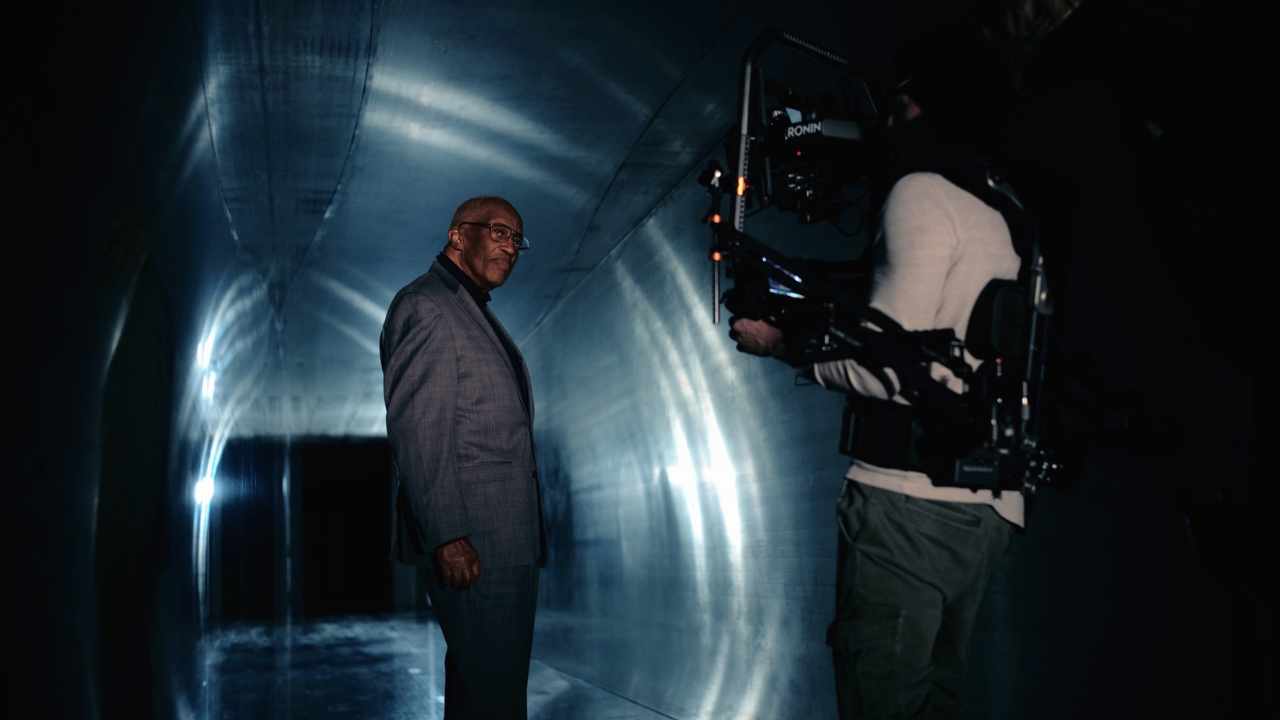a man in a suit being filmed