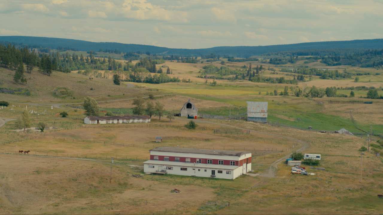 a large buiilding in the middle of a field