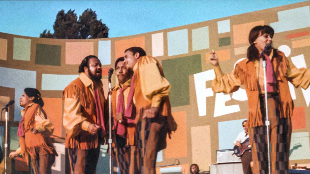 singers in fringed outfits on stage at a concert