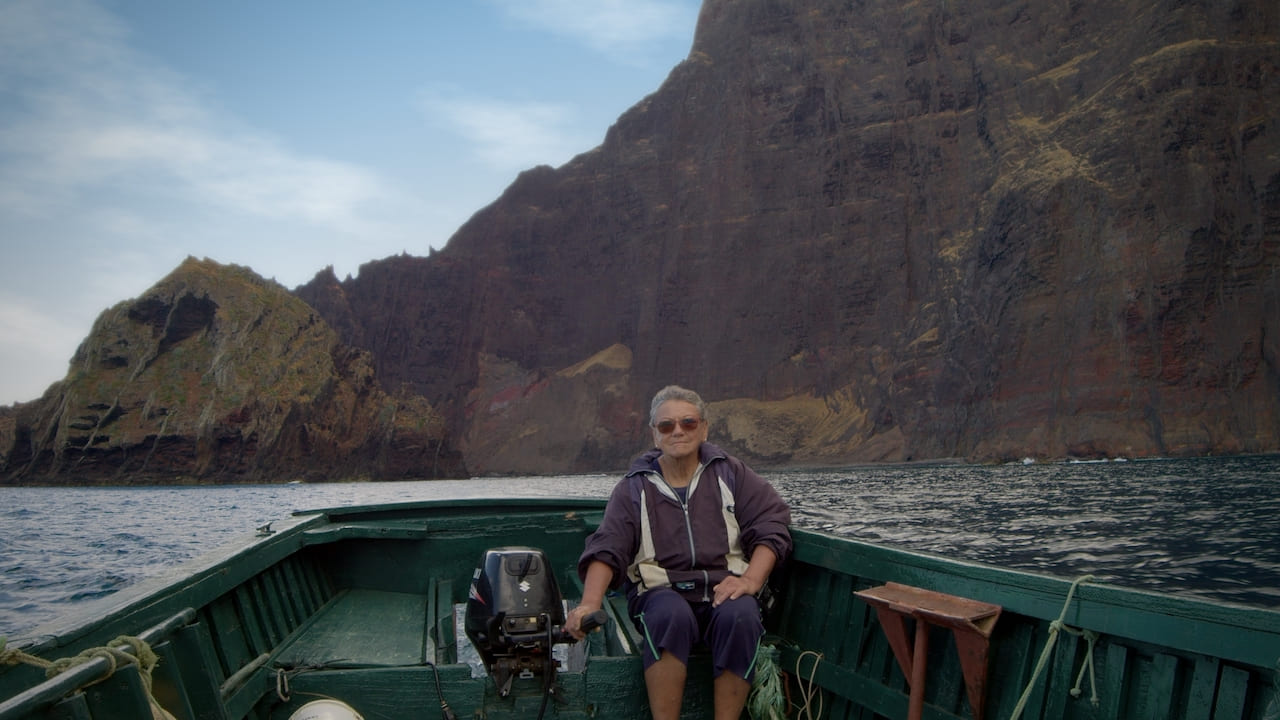 Woman sits in a wooden motor boat