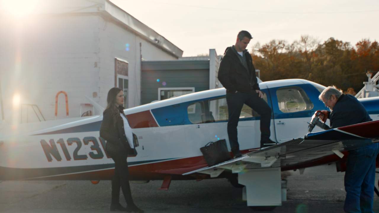 a man standing on the wing of a plane