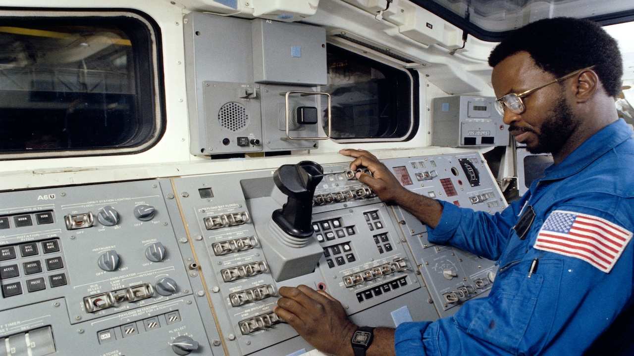 an astronaut working spaceship controls