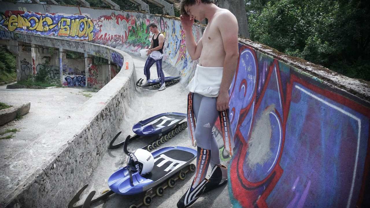 two lugers standing on a training track