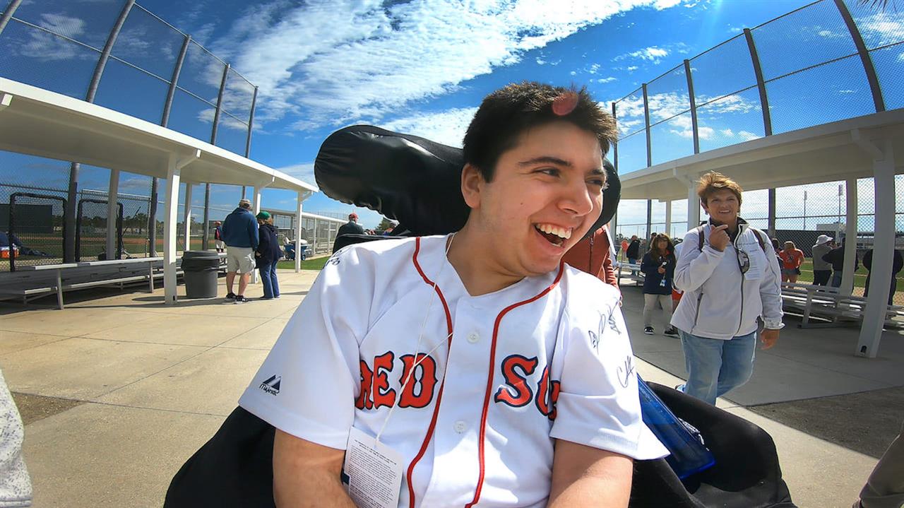 Man in wheelchair in Red Sox jersey outdoors