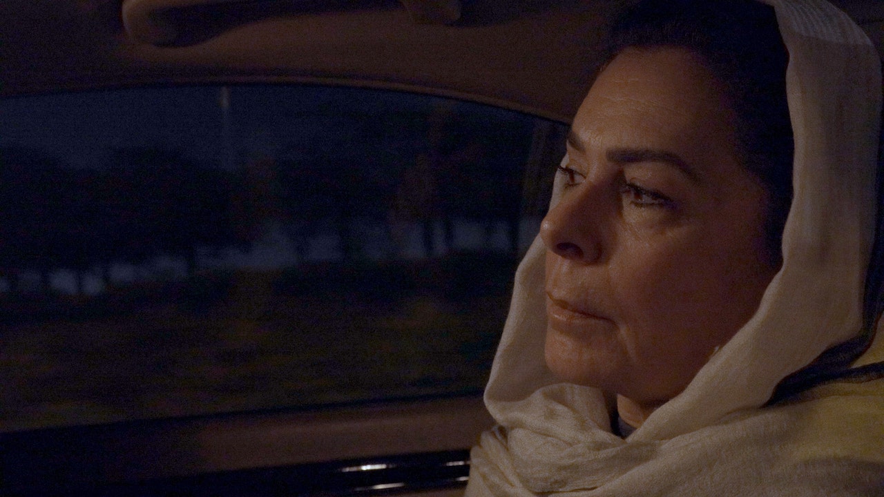 Closeup of a woman in a headscarf sitting in a car