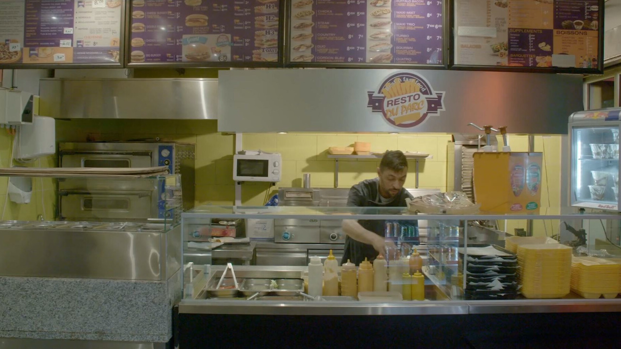 Man working behind a fast food counter