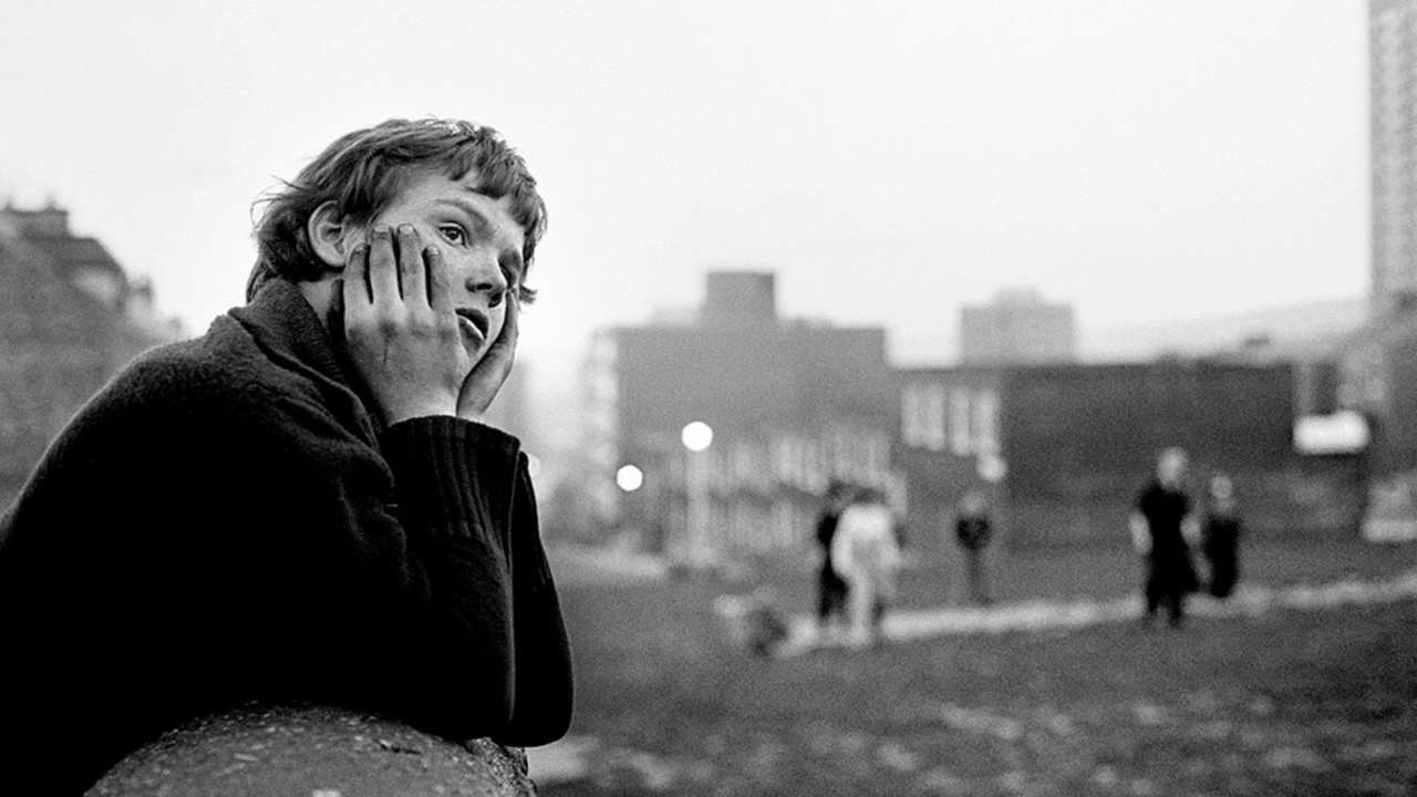 a woman leaning on a ledge