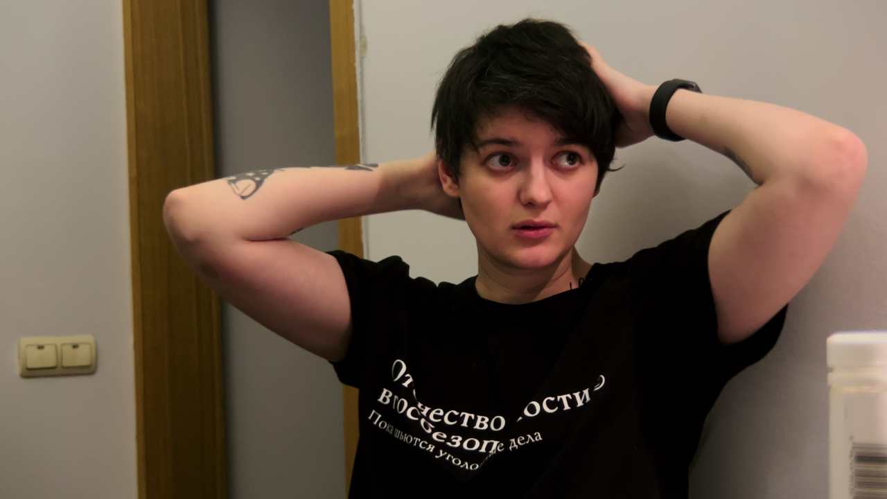 a person with their hands behind their head