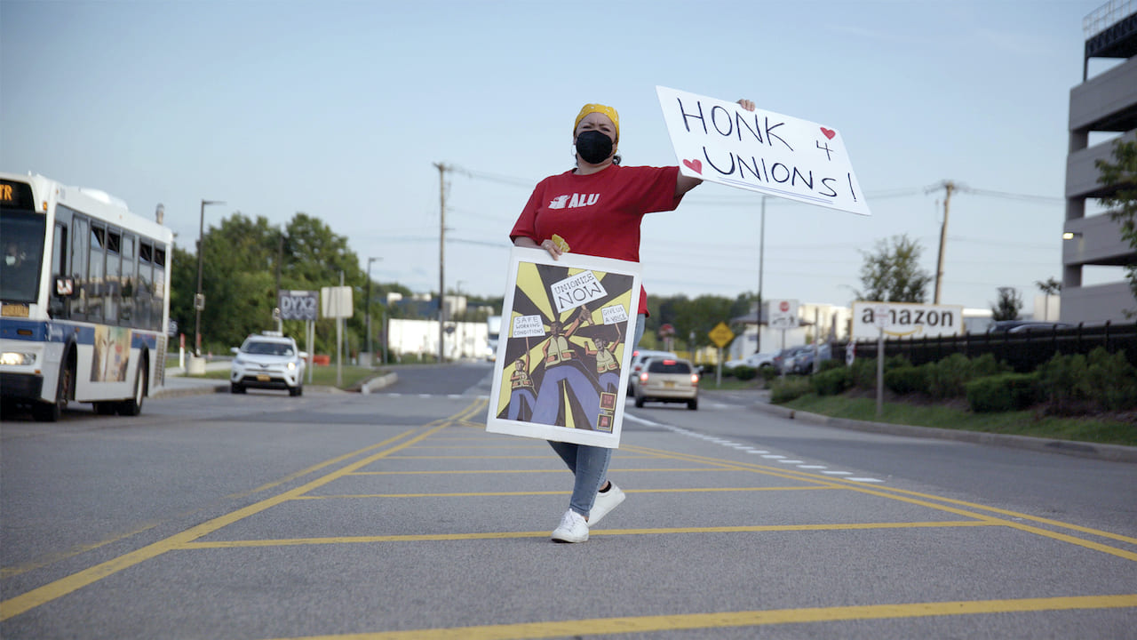 Woman with sign: Honk 4 Unions!