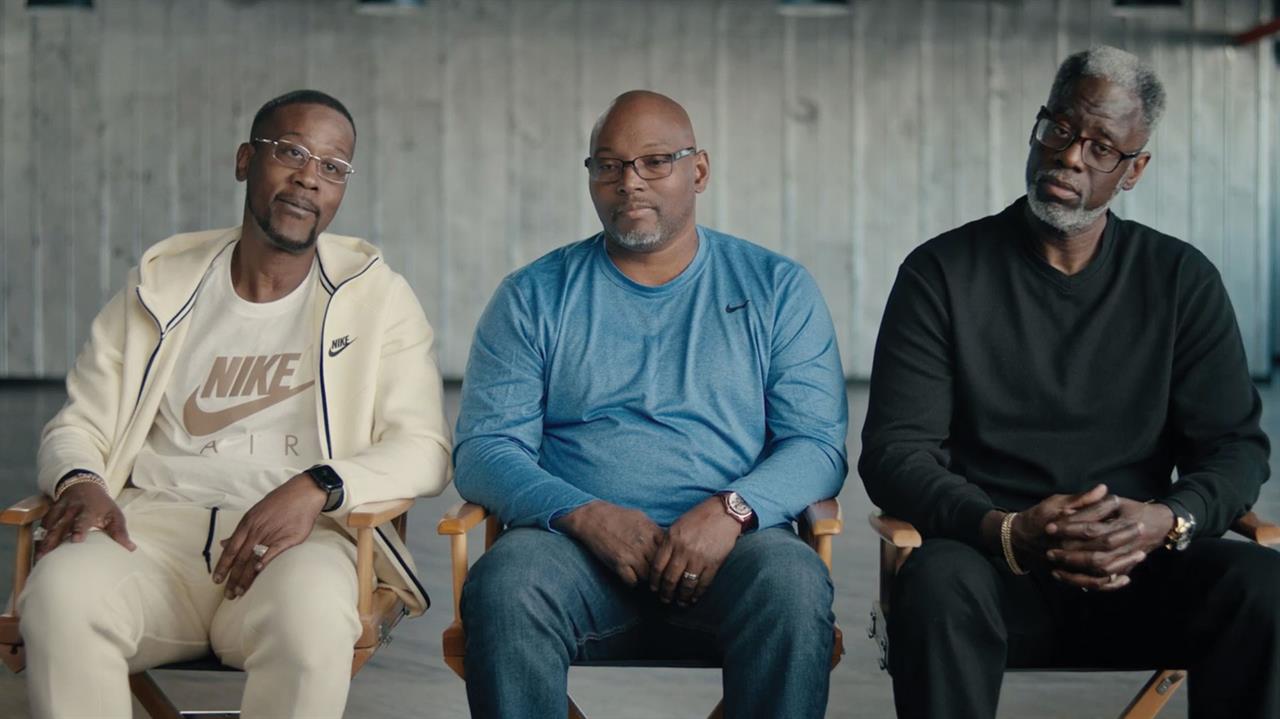 Three Black men sitting in chairs