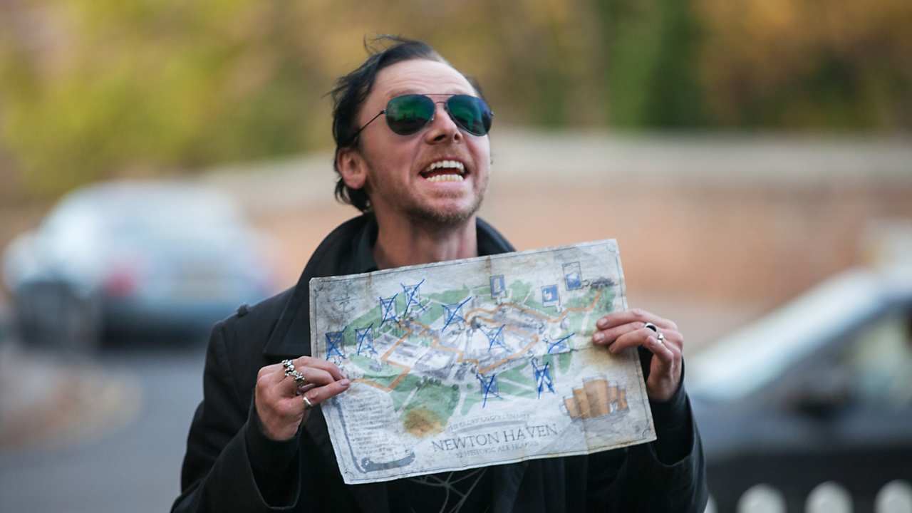 a man with sunglasses holding a map