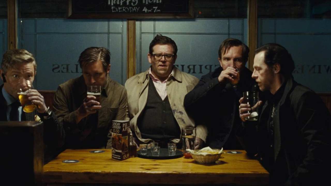 a group of 5 men drinking at a pub