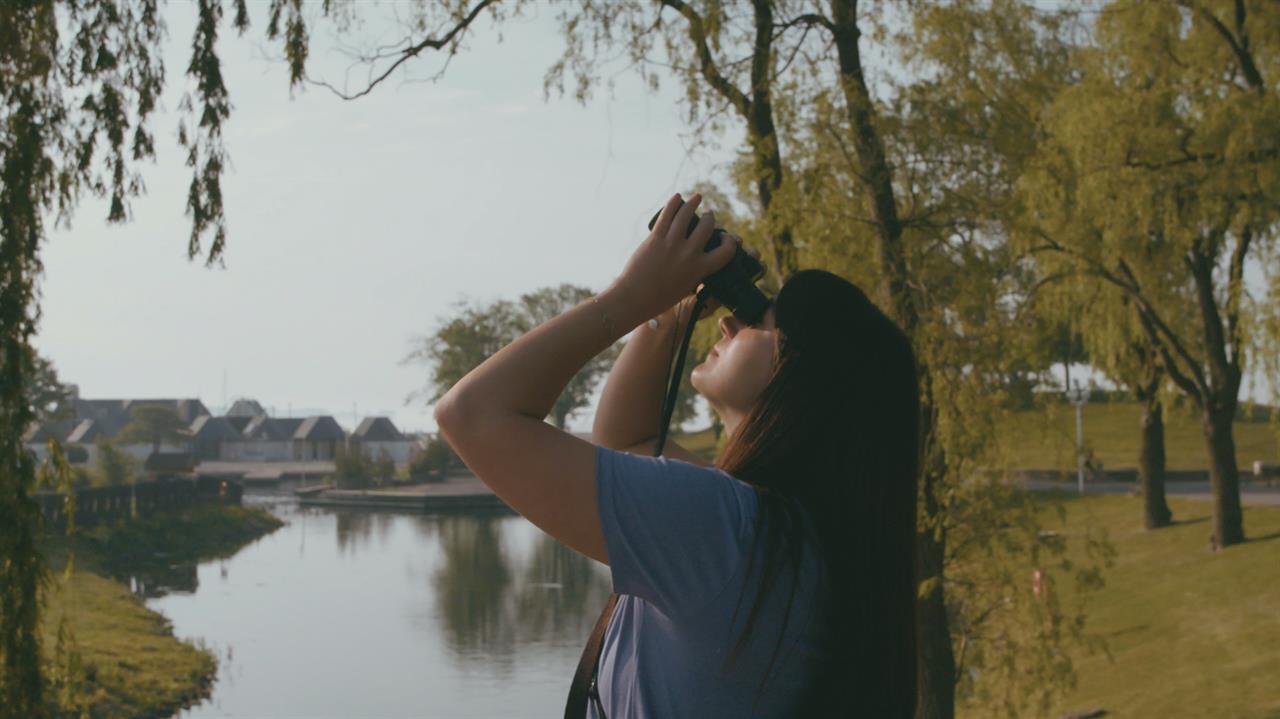 the girl looks into the binoculars