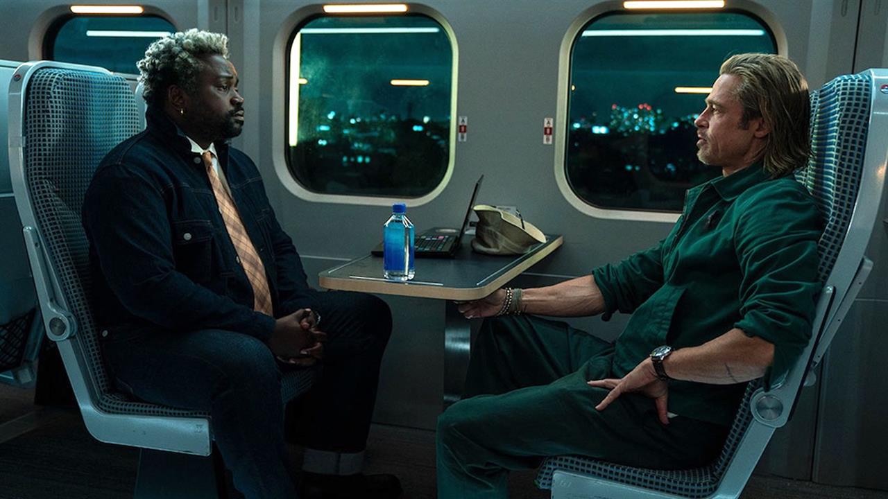 Brad Pitt and Brian Tyree Henry sitting across fro